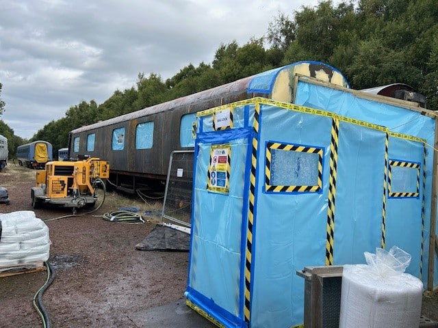 Asbestos bitumen removal from a heritage railway carriage